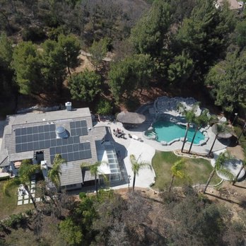 Aerial view of a ranch property with rooftop solar
