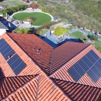 Solar panels across a terracotta tile roof
